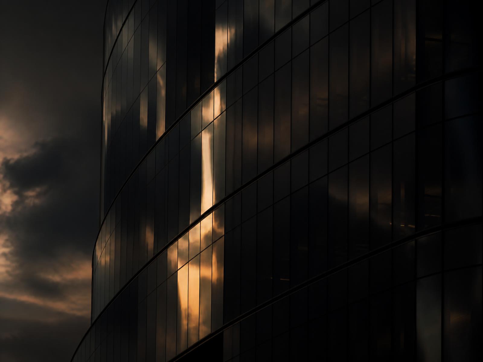 Dusk light across a modern glass tower
